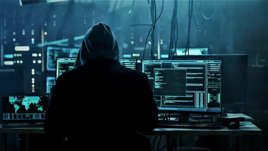 Person sitting in front of multiple computer monitors